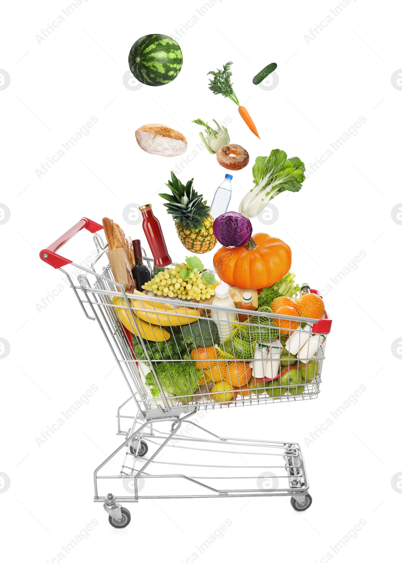 Image of Market assortment. Different products falling into shopping cart on white background