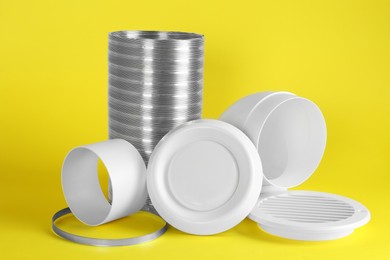 Photo of Parts of home ventilation system on yellow background