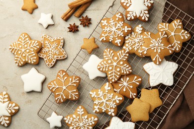 Photo of Tasty Christmas cookies with icing and spices on light table, flat lay