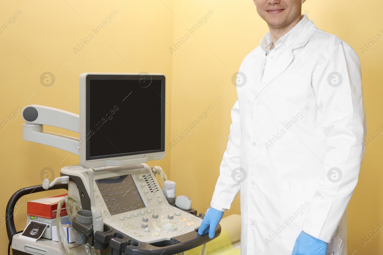 Photo of Doctor near ultrasound machine in clinic, closeup