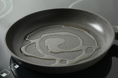 Frying pan with cooking oil on induction stove