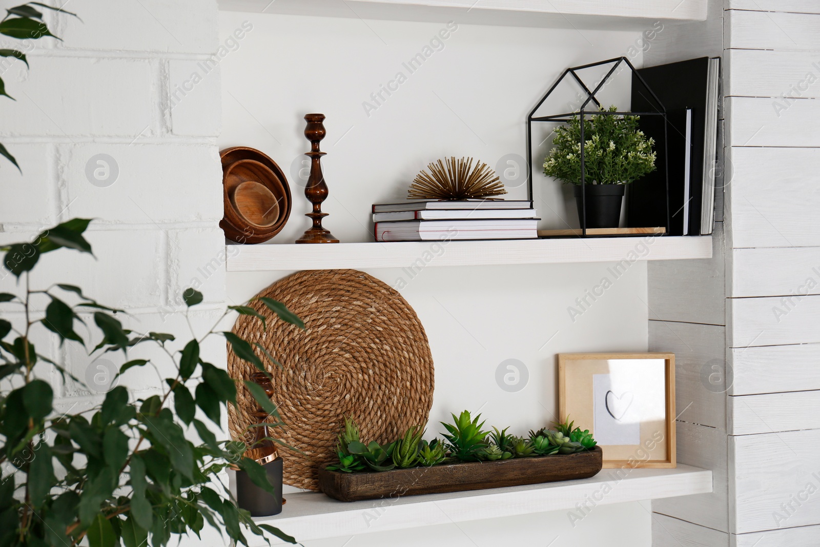 Photo of Wall shelves with beautiful decor elements indoors. Interior design