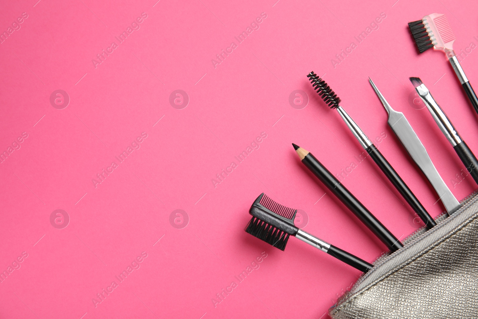 Photo of Set of professional eyebrow tools on pink background, flat lay. Space for text