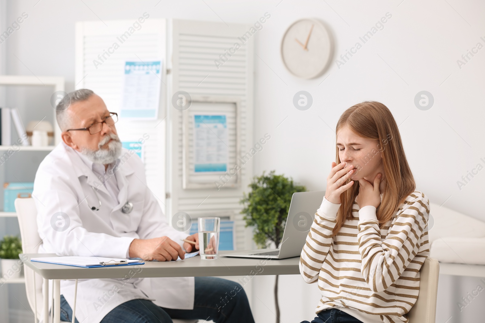 Photo of Coughing teenage girl visiting doctor at clinic