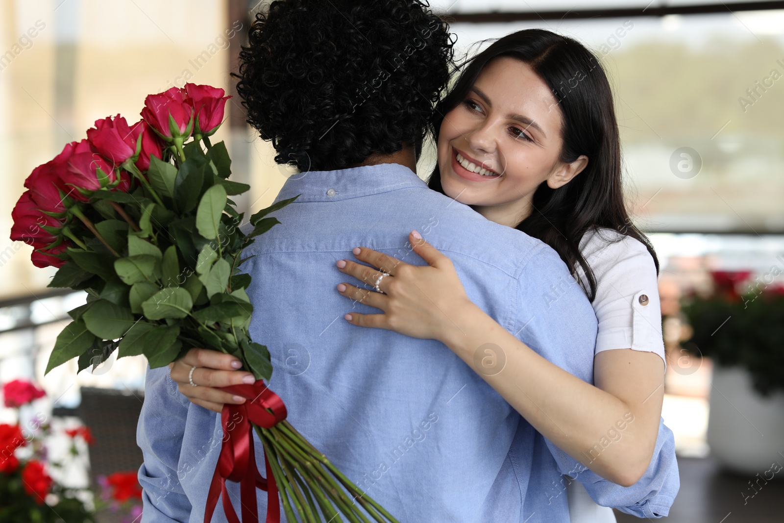 Photo of International dating. Happy couple hugging in restaurant