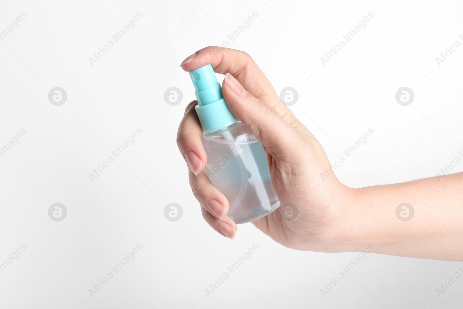 Photo of Woman holding antiseptic spray on white background, closeup