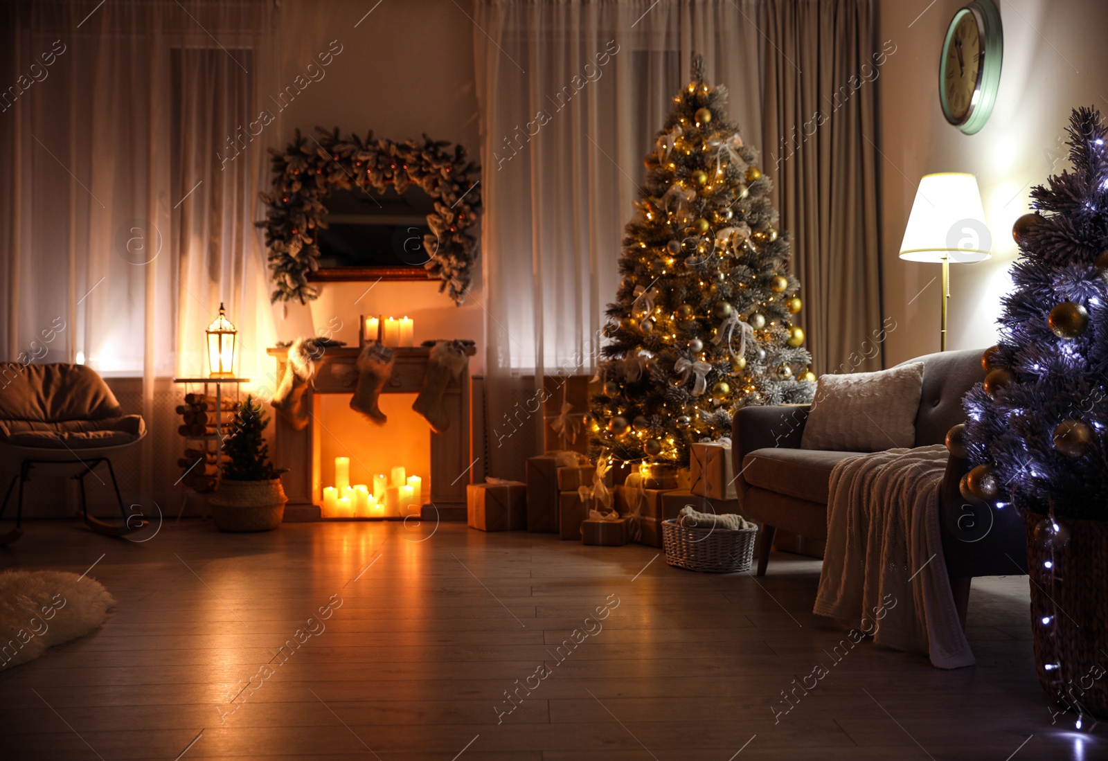 Photo of Stylish interior with beautiful Christmas tree and decorative fireplace at night