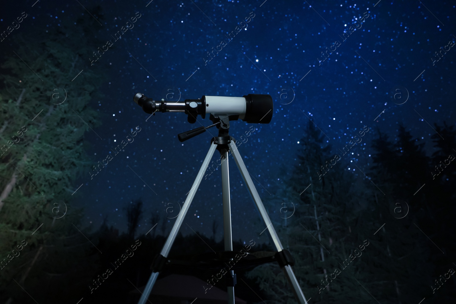 Photo of Modern telescope at night outdoors. Learning astronomy