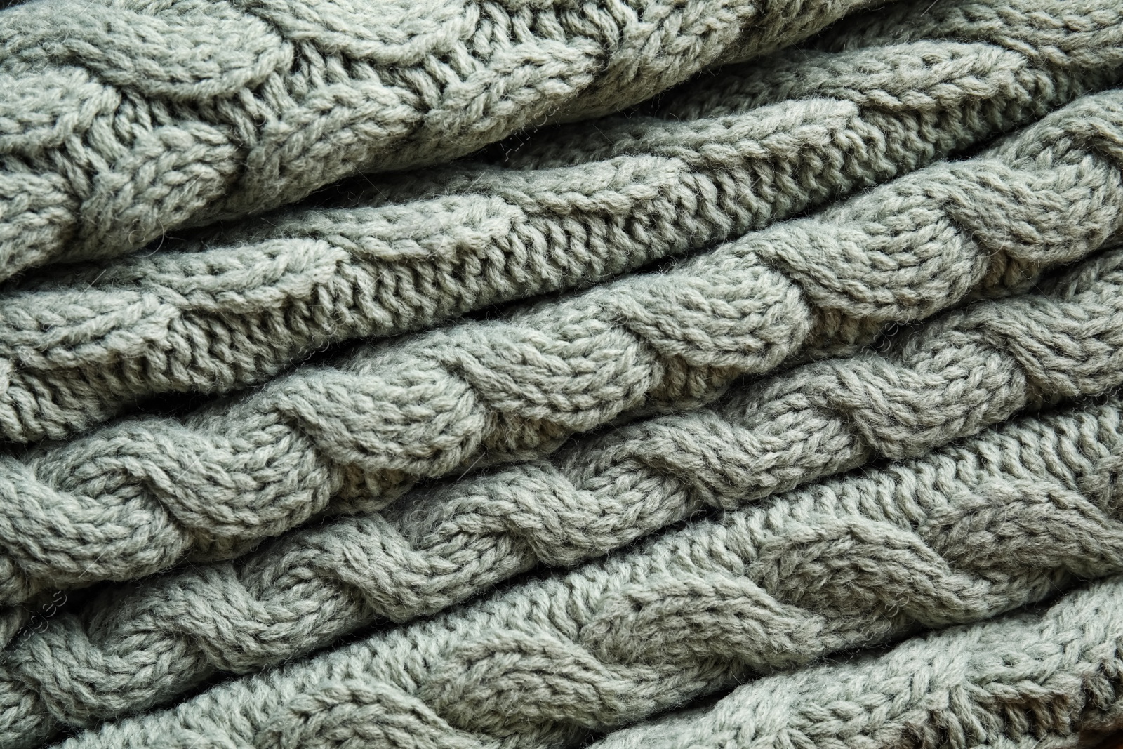 Photo of Soft knitted plaid as background, closeup view