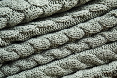 Photo of Soft knitted plaid as background, closeup view