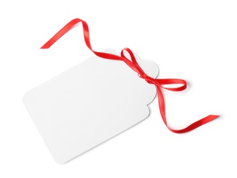 Photo of Blank gift tag with satin ribbon on white background, top view