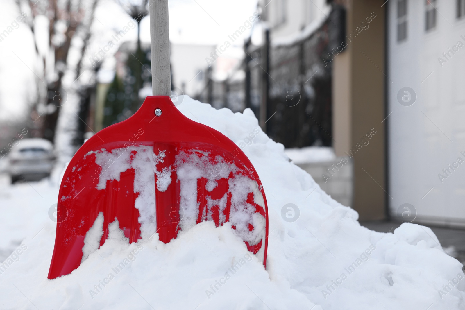 Photo of Snow shovel with wooden handle outdoors. Space for text