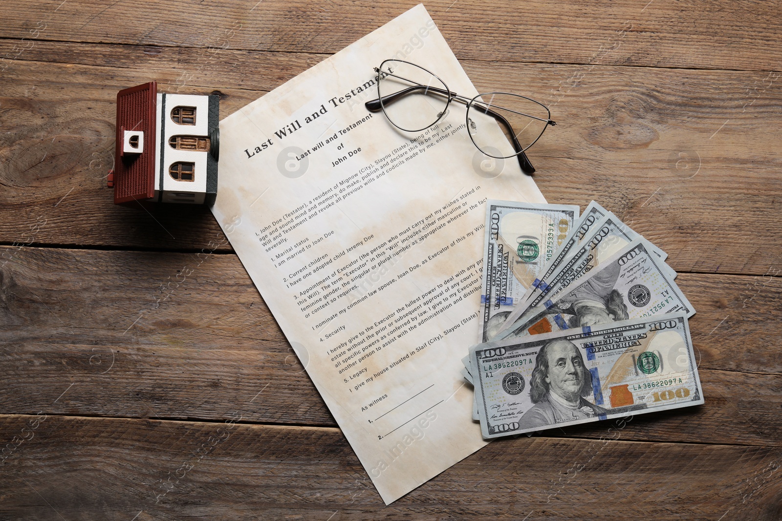 Photo of Last Will and Testament, house model, dollar bills and glasses on wooden table, flat lay