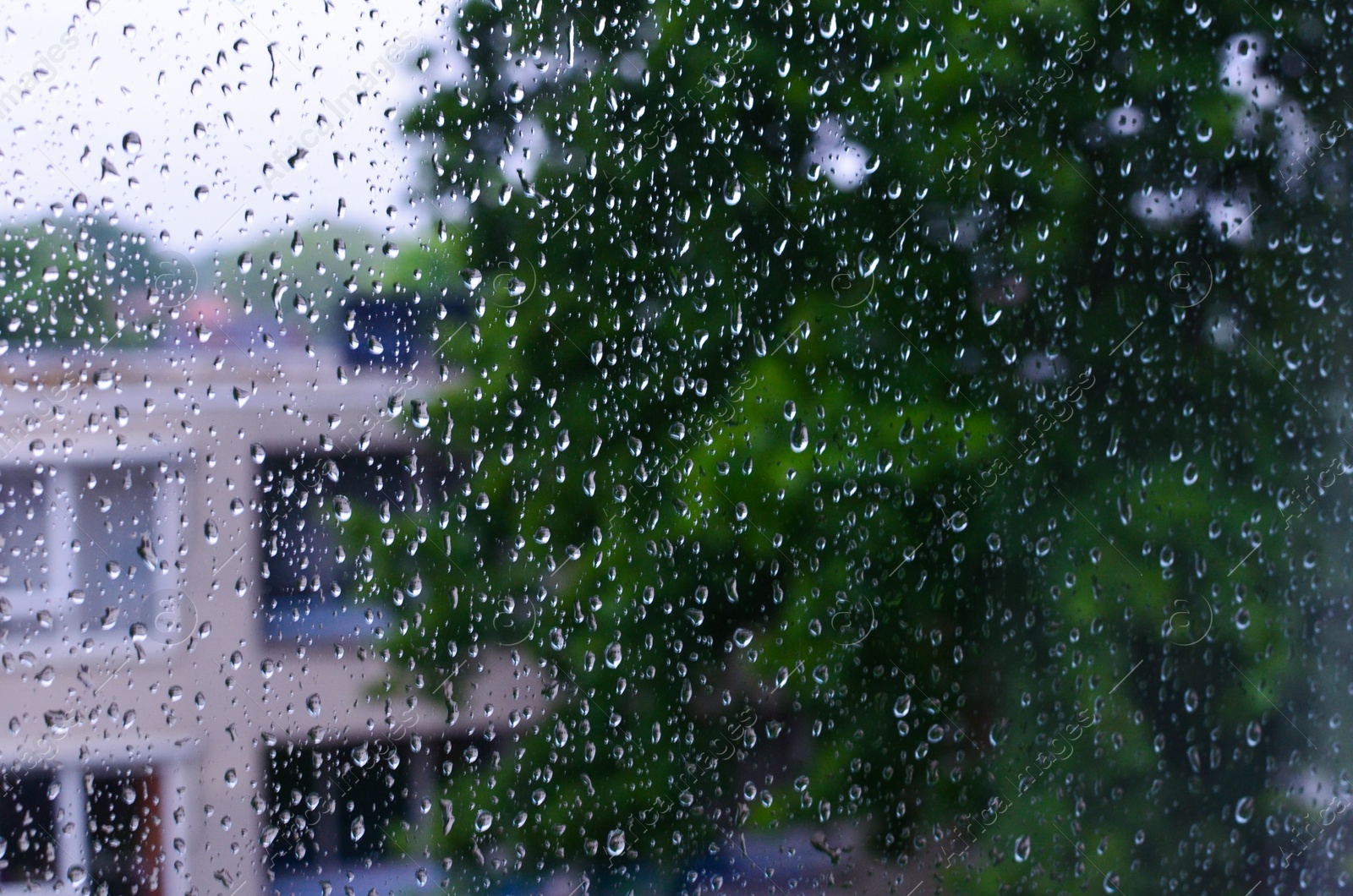 Photo of Window glass with water drops, closeup. Rainy weather