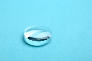 Pure water drop on color background, closeup. Space for text