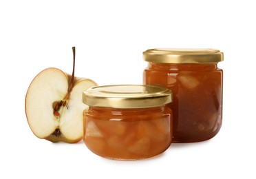 Photo of Tasty apple jam in glass jars and fresh fruit on white background
