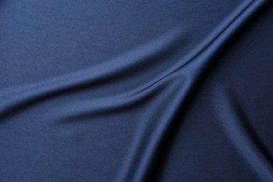 Photo of Texture of blue crumpled silk fabric as background, top view