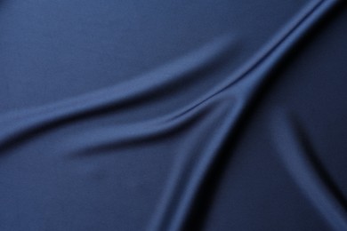 Texture of blue crumpled silk fabric as background, top view