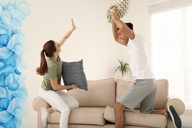 Photo of Happy couple having pillow fight in living room