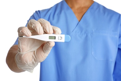 Male doctor holding digital thermometer on white background, closeup. Medical object