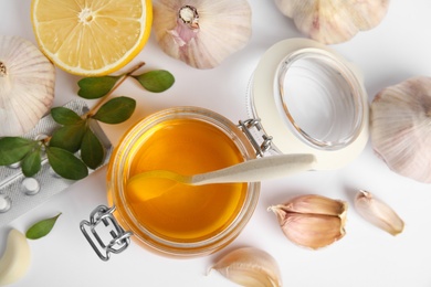 Photo of Composition with garlic and other cold remedies on white background, top view