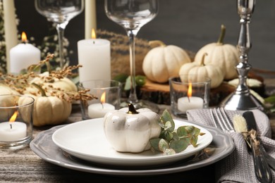 Beautiful autumn place setting and decor on wooden table