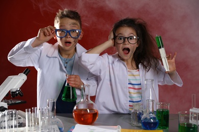 Photo of Children doing chemical research in laboratory. Dangerous experiment