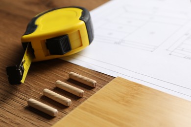 Composition with furniture parts and tools for self-assembly on wooden background, closeup