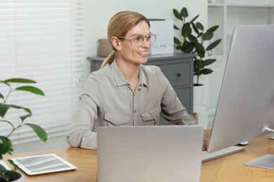 Professional accountant working at wooden desk in office