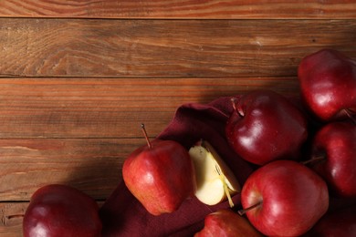 Photo of Fresh ripe red apples on wooden table, flat lay. Space for text