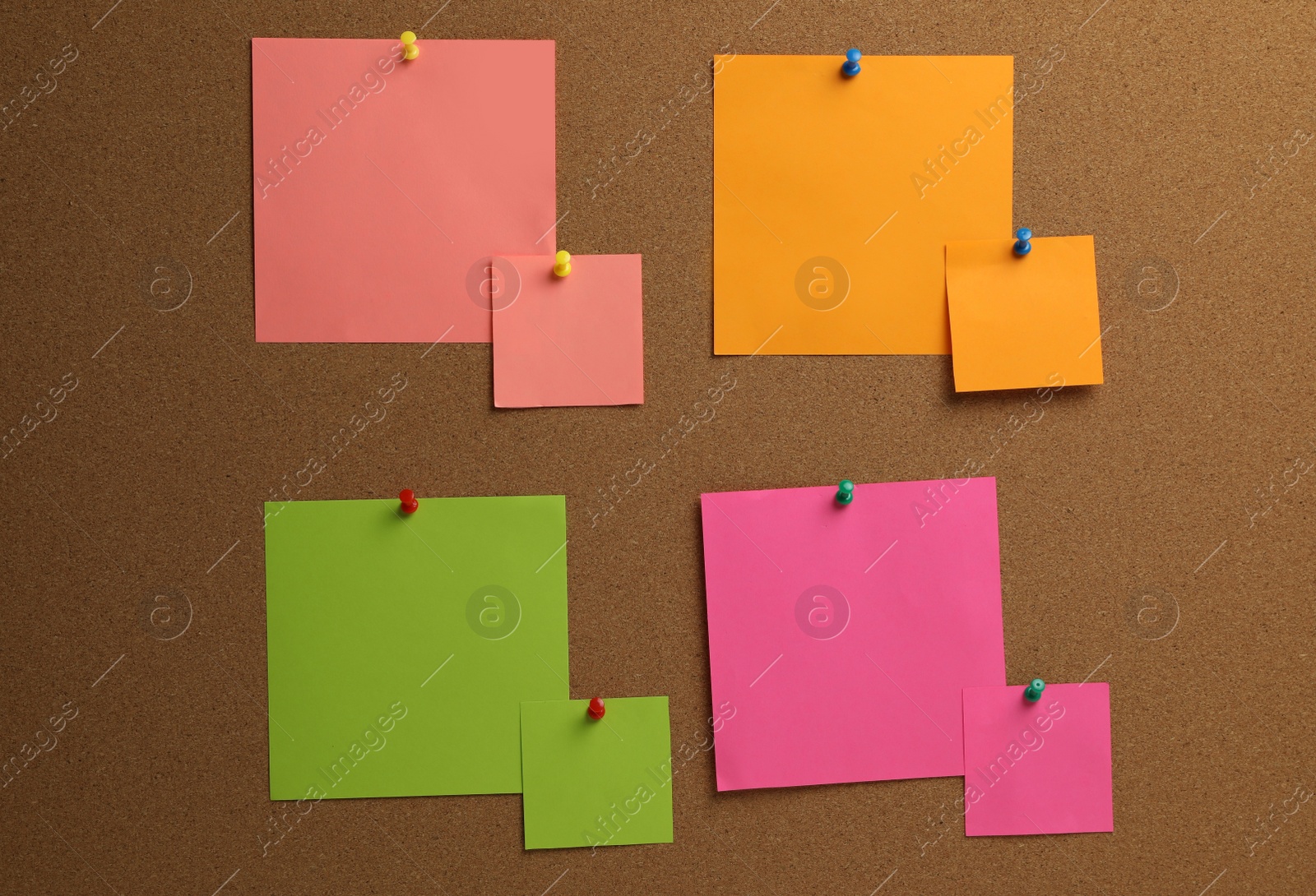 Photo of Colorful paper notes pinned to cork board