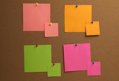 Photo of Colorful paper notes pinned to cork board