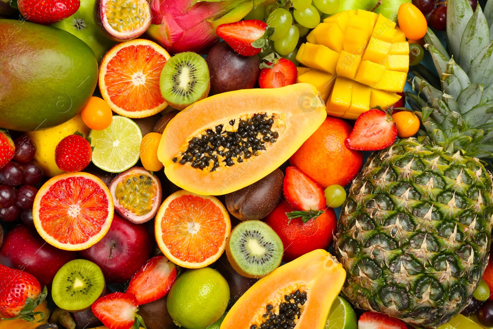 Photo of Many different delicious exotic fruits as background, top view