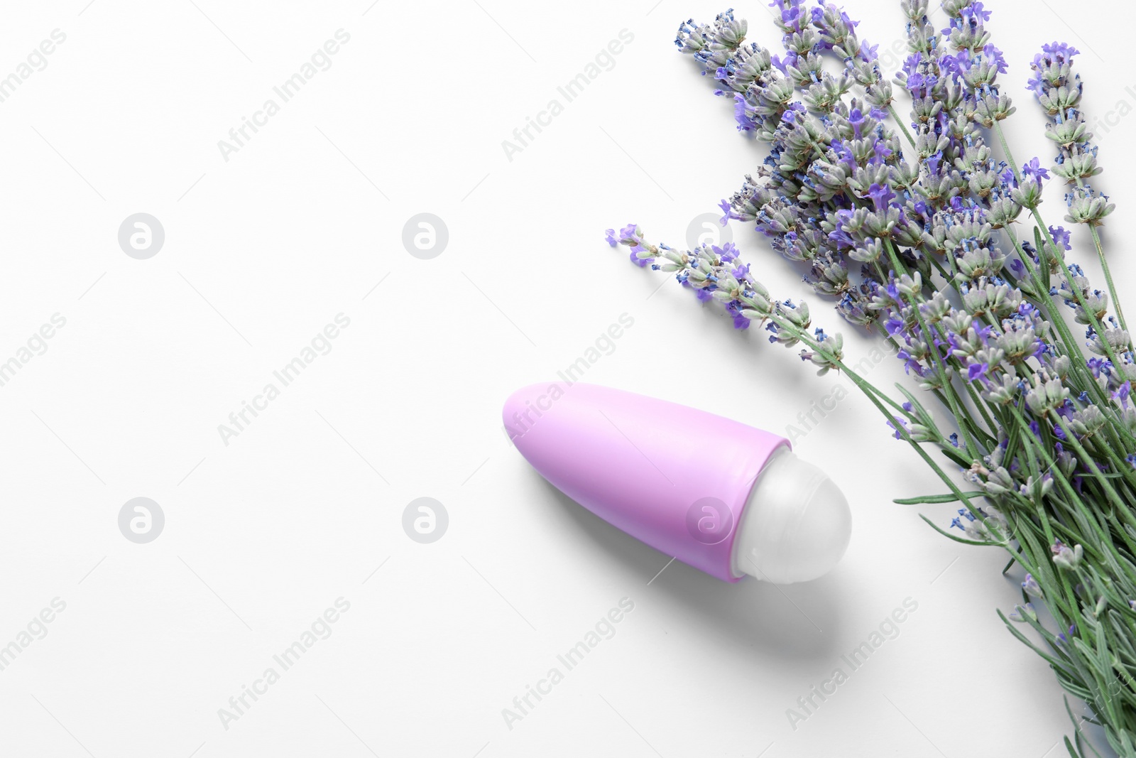 Photo of Female deodorant and lavender flowers on white background, top view