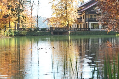 Photo of Beautiful landscape with country house near forest and river on sunny day