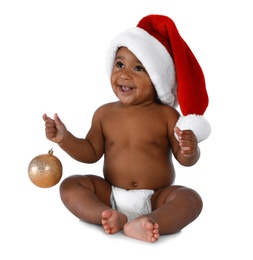 Photo of Cute African-American baby wearing Santa hat with Christmas decoration on white background