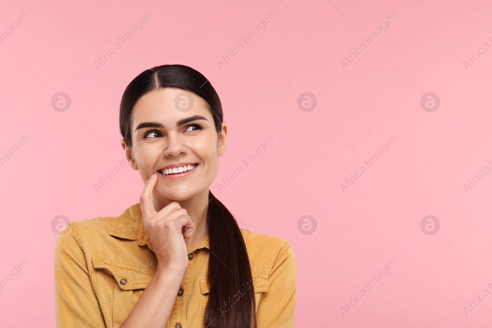 Photo of Woman showing her clean teeth and smiling on pink background, space for text