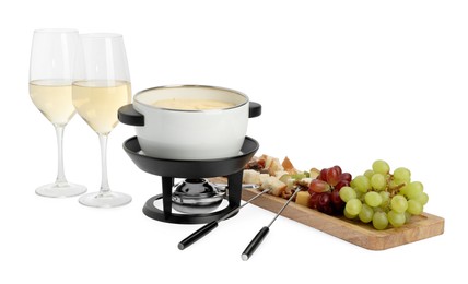 Photo of Fondue with tasty melted cheese, forks, different snacks and wine isolated on white