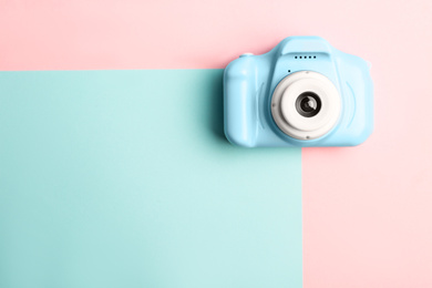 Photo of Light blue toy camera on color background, top view with space for text. Future photographer