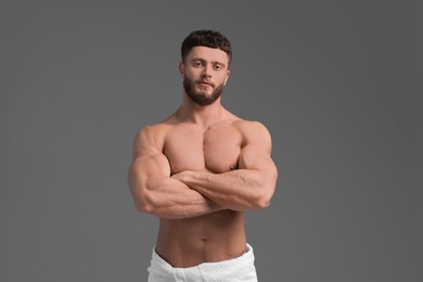 Handsome muscular man on grey background. Sexy body