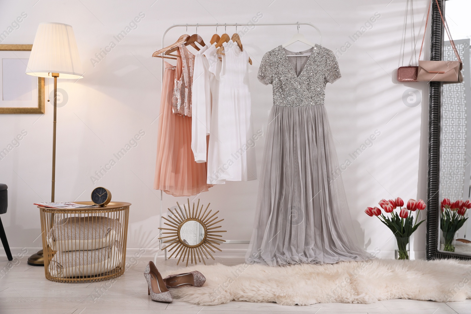 Photo of Rack with stylish women's clothes indoors. Interior design