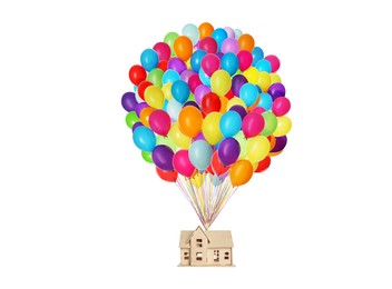 Many balloons tied to model of house flying on white background