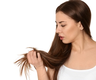 Photo of Emotional woman with damaged hair on white background. Split ends