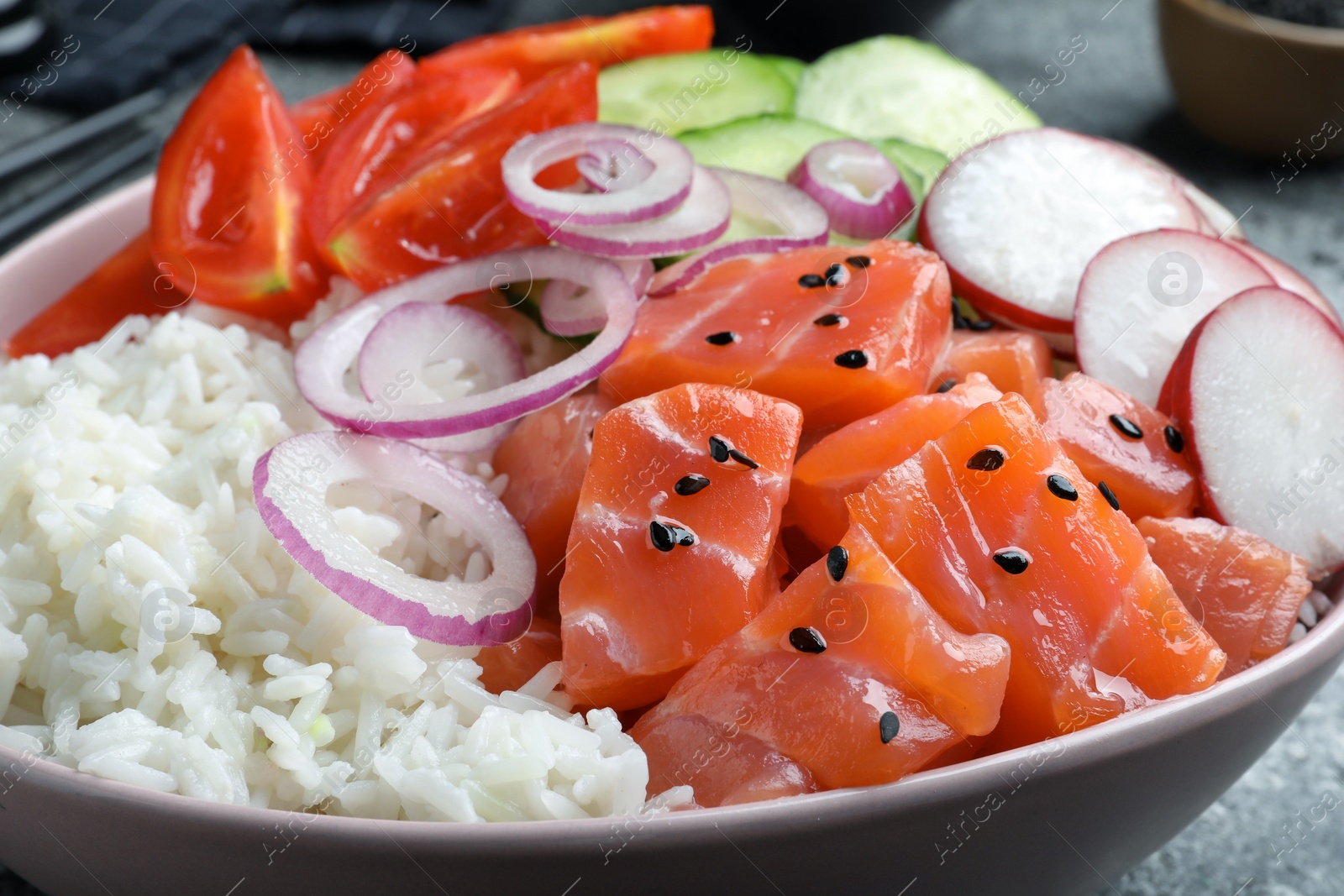 Photo of Delicious poke bowl with salmon and vegetables on table, closeup