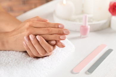 Photo of Woman waiting for manicure at table, closeup with space for text. Spa treatment