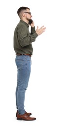 Man in shirt and jeans talking on phone on white background