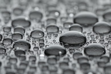 Water drops on grey background, closeup view