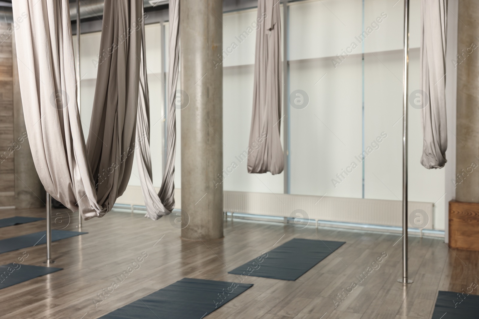 Photo of Many hammocks for fly yoga in studio, space for text