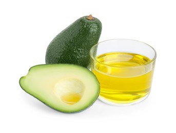 Photo of Bowl with oil and fresh avocados on white background