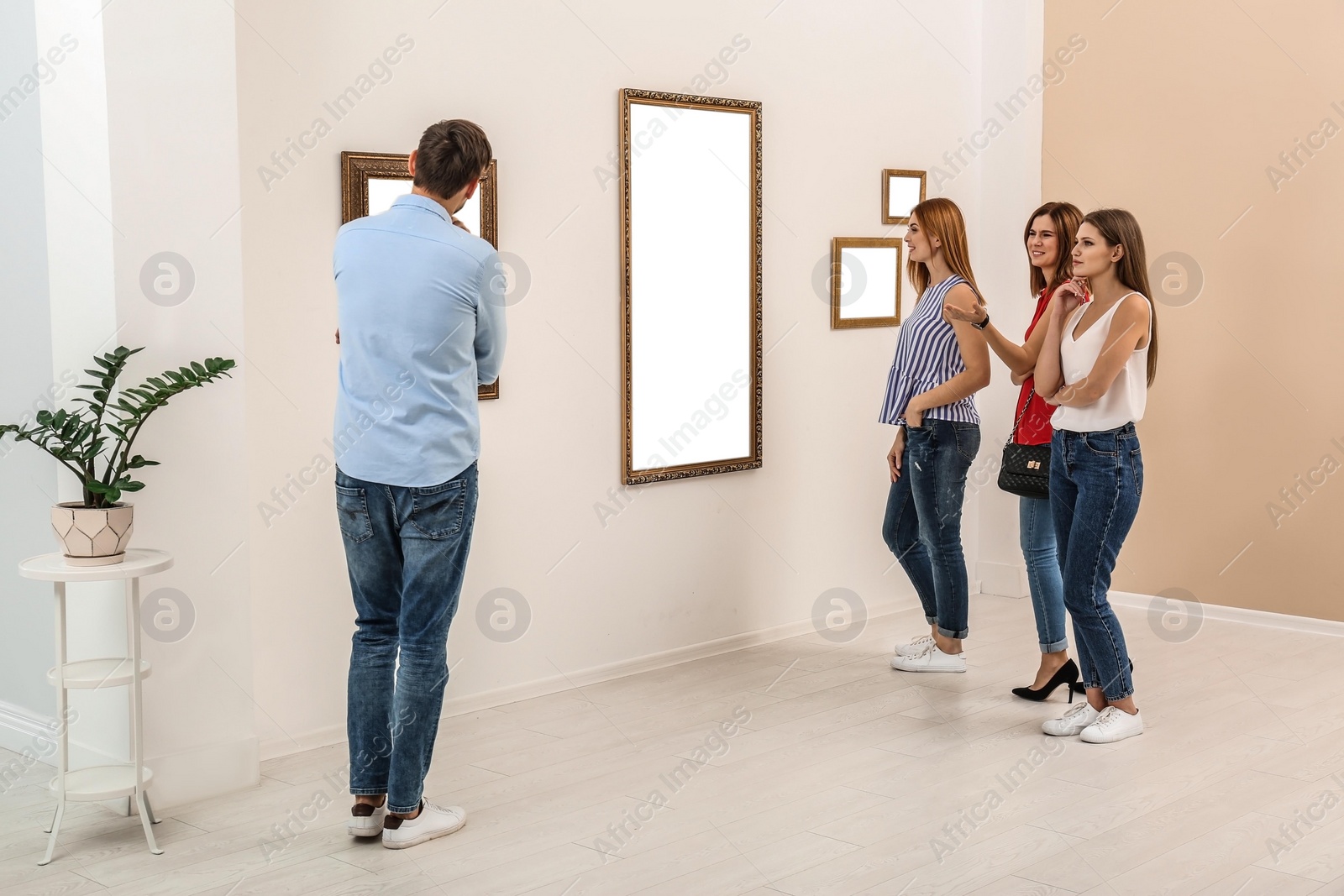 Photo of People viewing exposition in modern art gallery